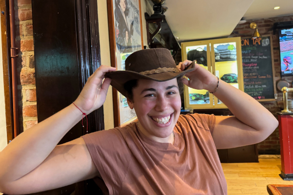 Lab member smiling and wearing a cowboy hat.