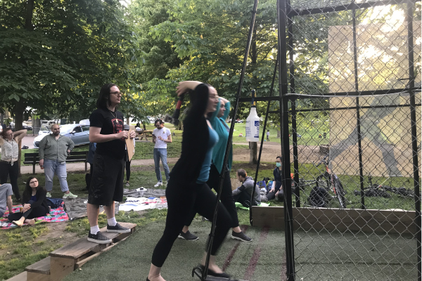 Members of the herbert lab throwing axes at the throw house event.