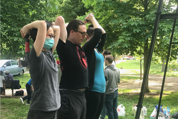 Three members of the herbert lab throwing axes at the throw house event.