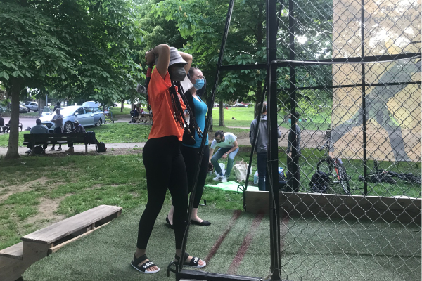 Two members of the herbert lab throwing axes at the throw house event.